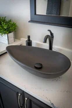 Pod Shaped Vessel Sink in Honed Lava Stone Above Counter / Vessel Sinks